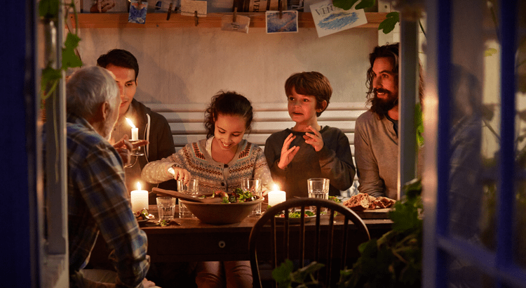 A family enjoying dinner together after moving closer to each other.