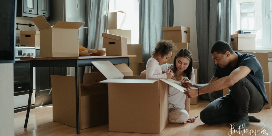 Happy family unpacking boxes together in their new home