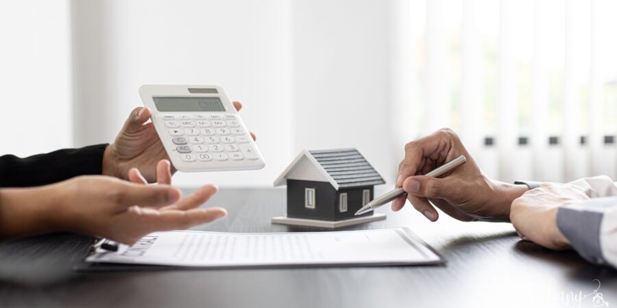 First-time homebuyer reviewing homeownership costs with paperwork and calculator